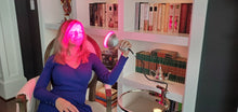 Woman Using Red Light Therapy Bulb on Face