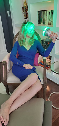 Woman Using Green Light Therapy on Her Head.
