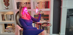 Woman Relaxing While Using Large Red Light Therapy Bulb